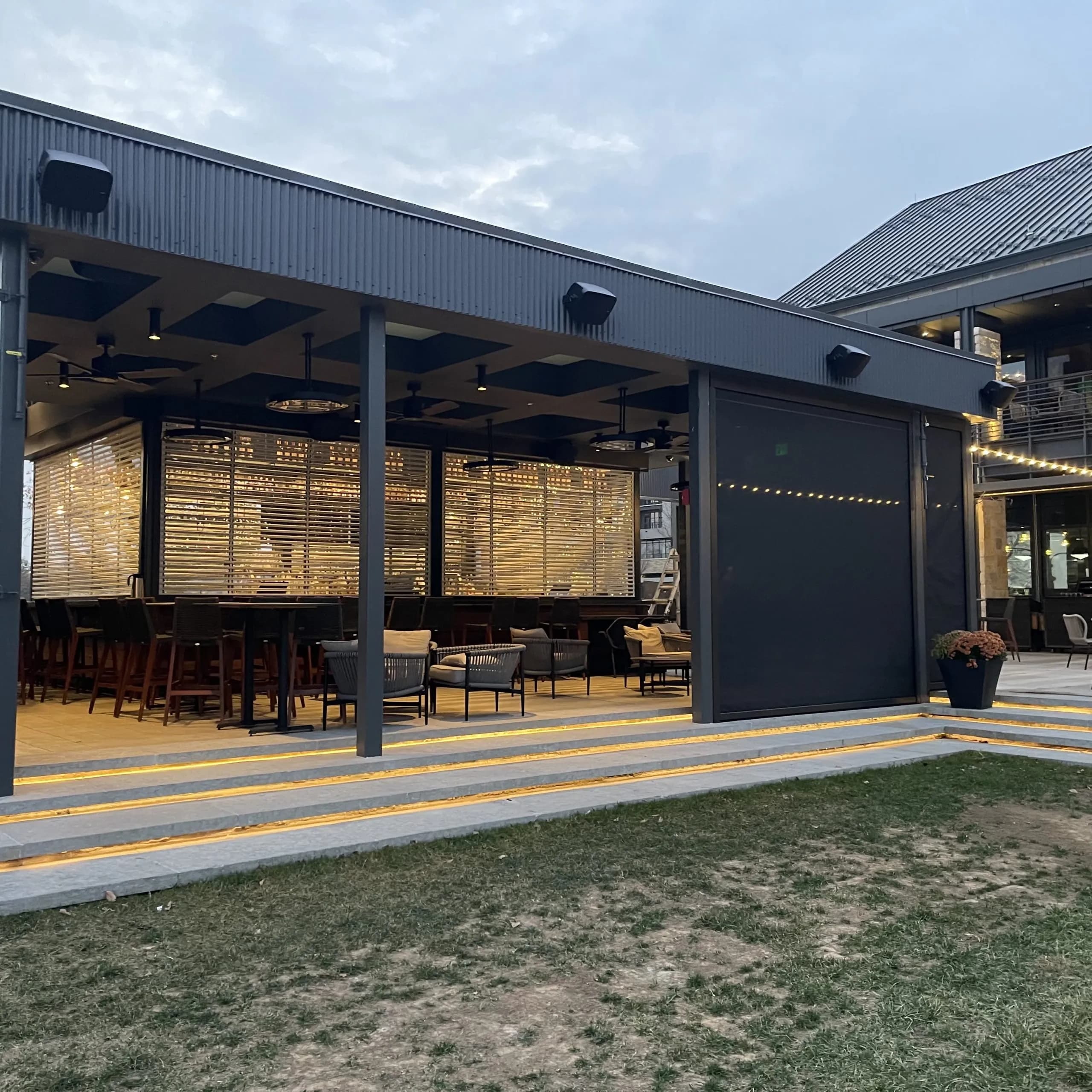 Modern outdoor restaurant with lighted patio and stylish seating area.
